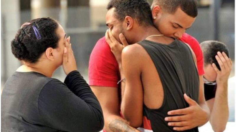 People grieving following shooting attack on a gay nightclub in Orlando, Florida.