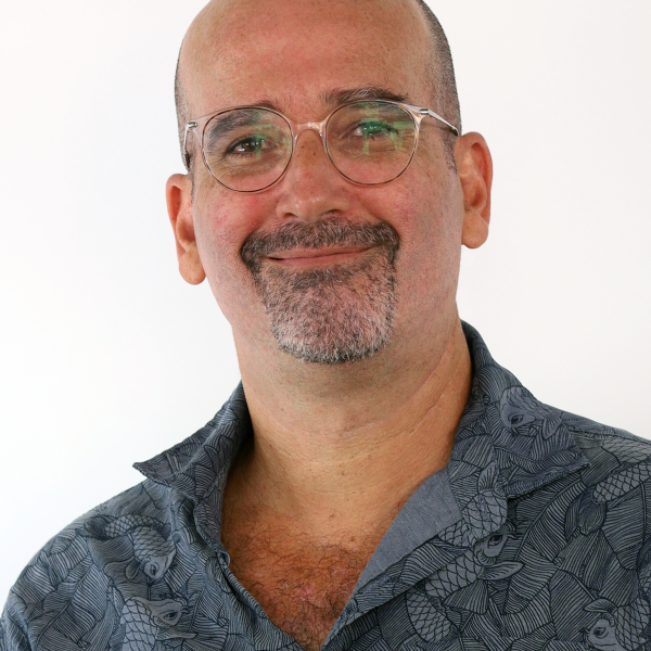 A photo of JuanMa smiling at the camera, white background