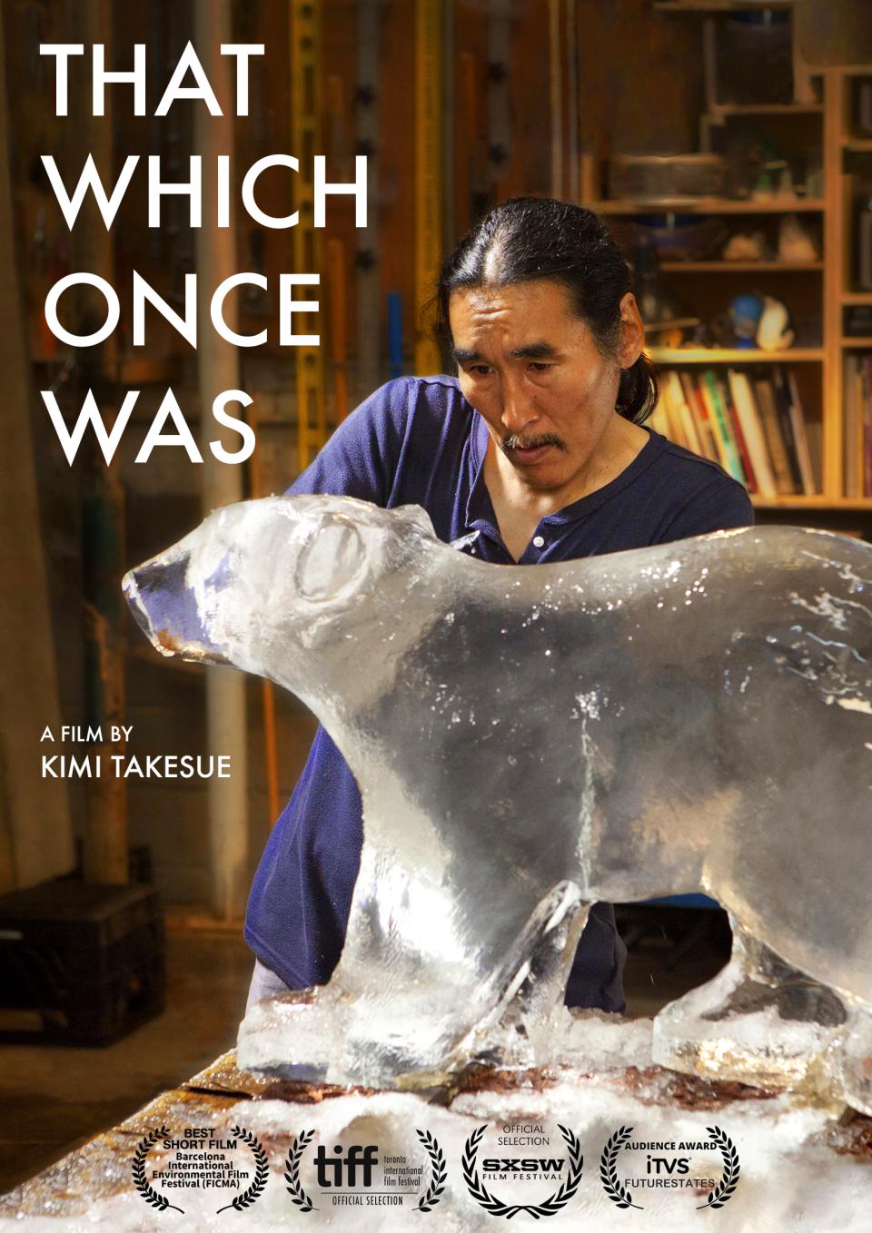 An Inuk ice carver carves an ice bear