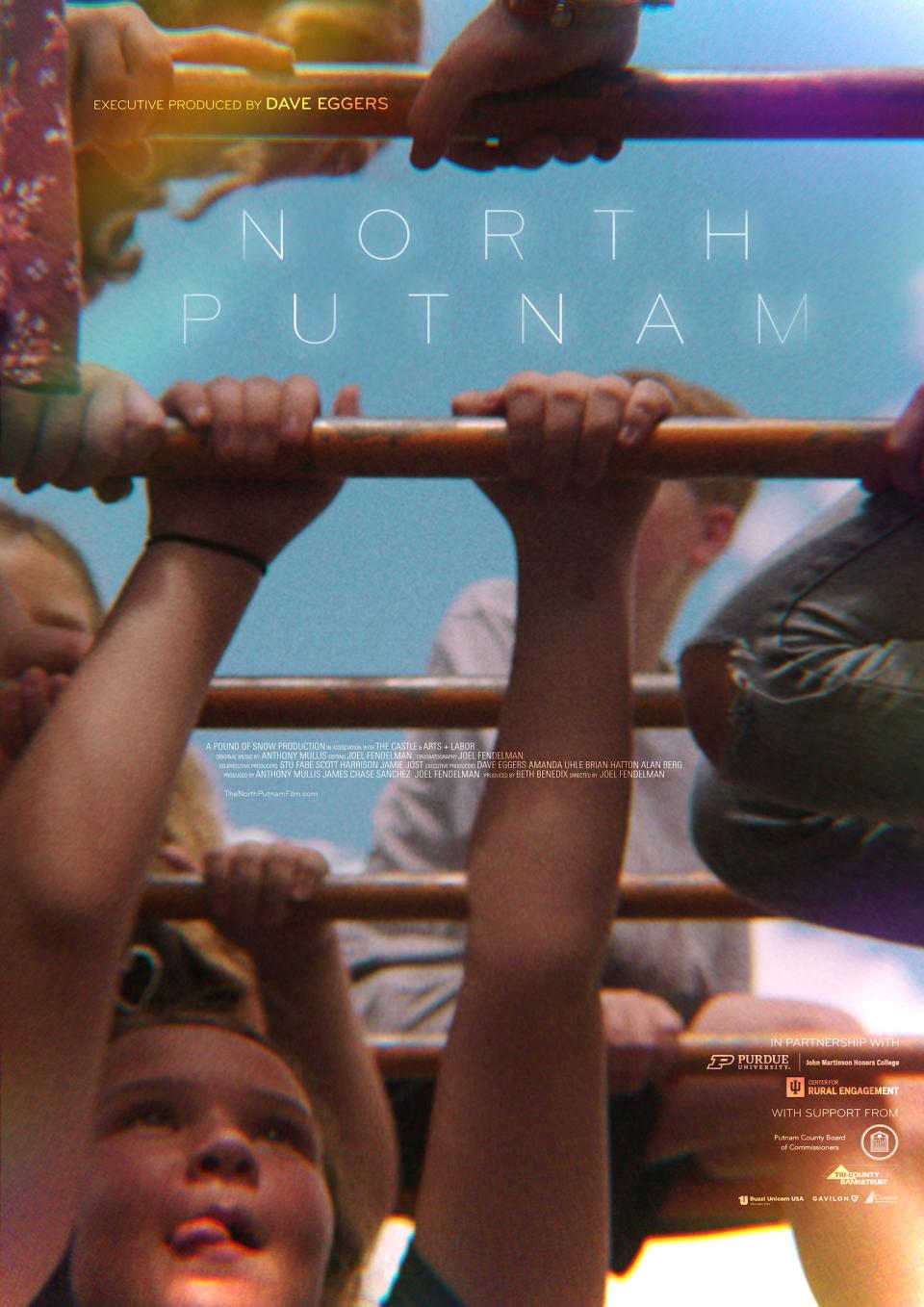 A close-up of a child hanging from monkey bars, other children are in the background, crowding the scene. The title "North Putnam" is embedded over the photo with additional text related to the film. 