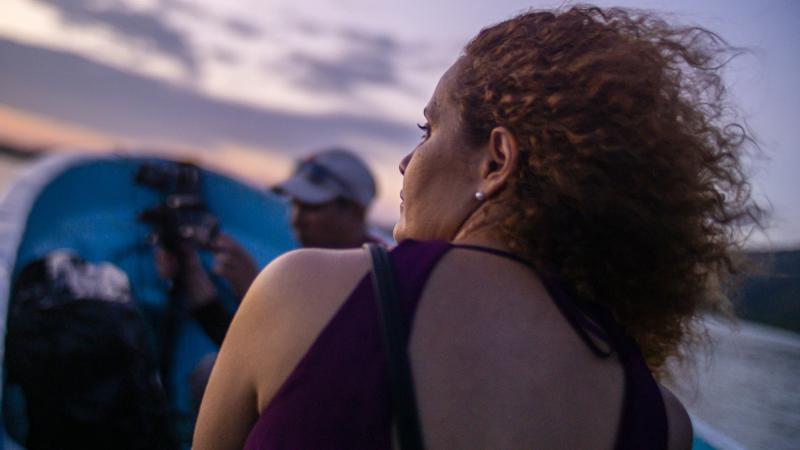 New Day Director Anike Tourse on set outdoors with her back facing away from the viewer.