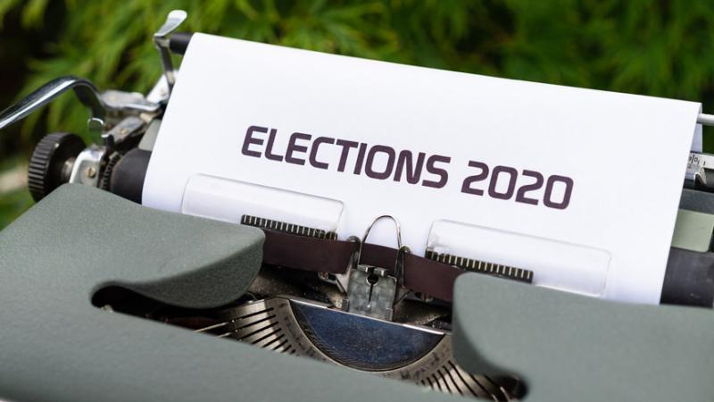 Outside, a gray manual typewriter. A sheet of paper in the typewriter reads “Elections 2020” in all capital letters.