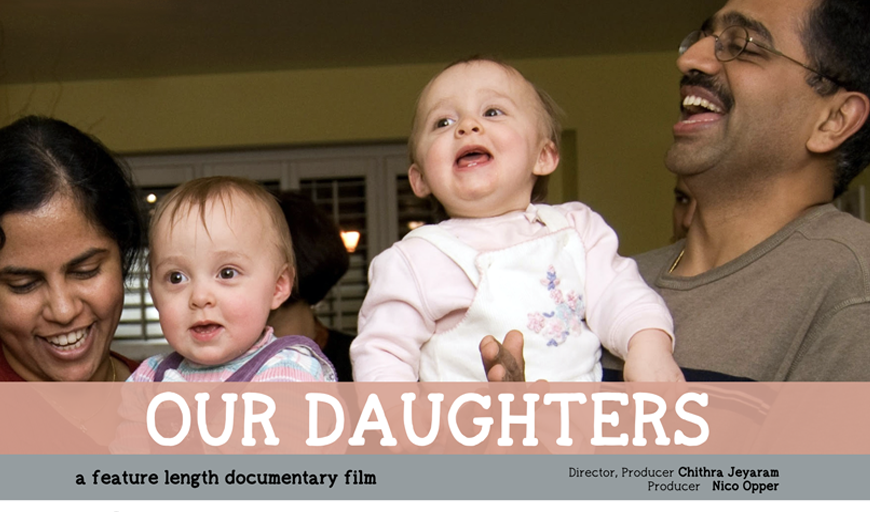 A brown-skinned heterosexual couple is smiling while holding two white babies. Text: “Our Daughters: a feature length documentary. Director, Producer: Chithra Jeyaram. Producer: Nico Opper.”