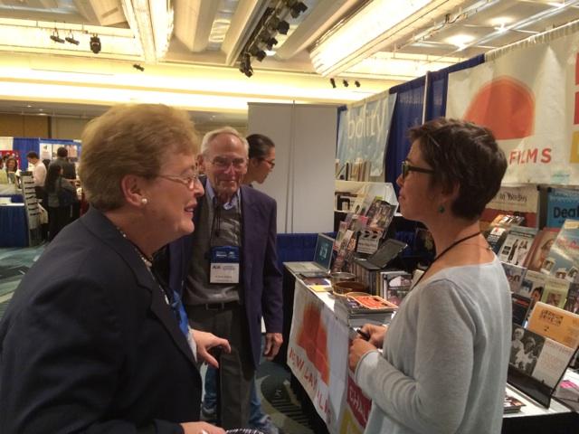 New Day filmmaker Vanessa Warheit chats with two conference attendees.