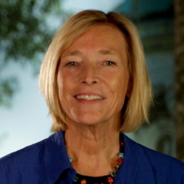 face of white woman, short blond hair, smiling at camera.