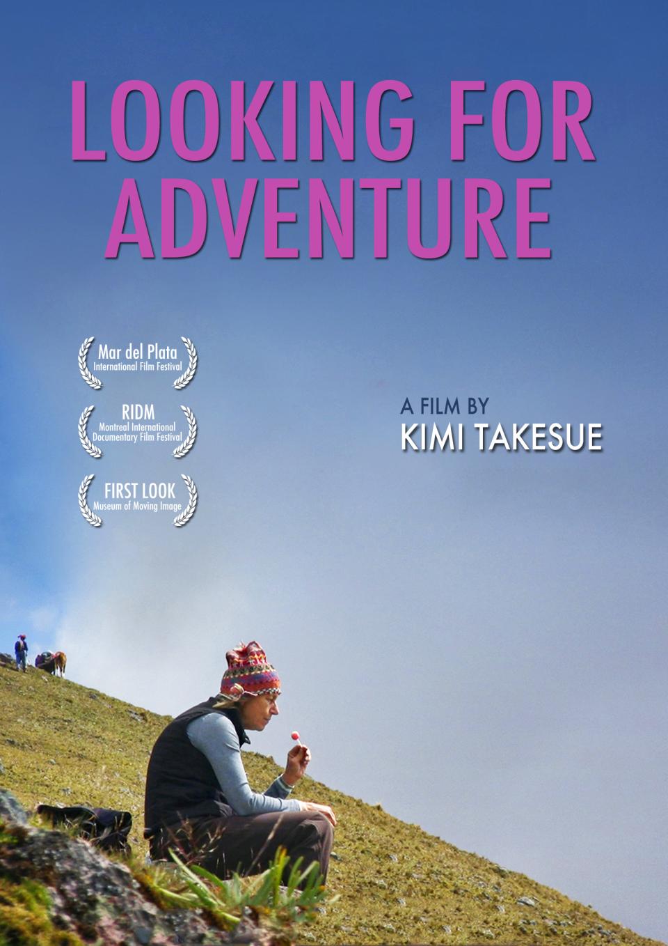 woman sits on mountaintop in peru holding a lollipop