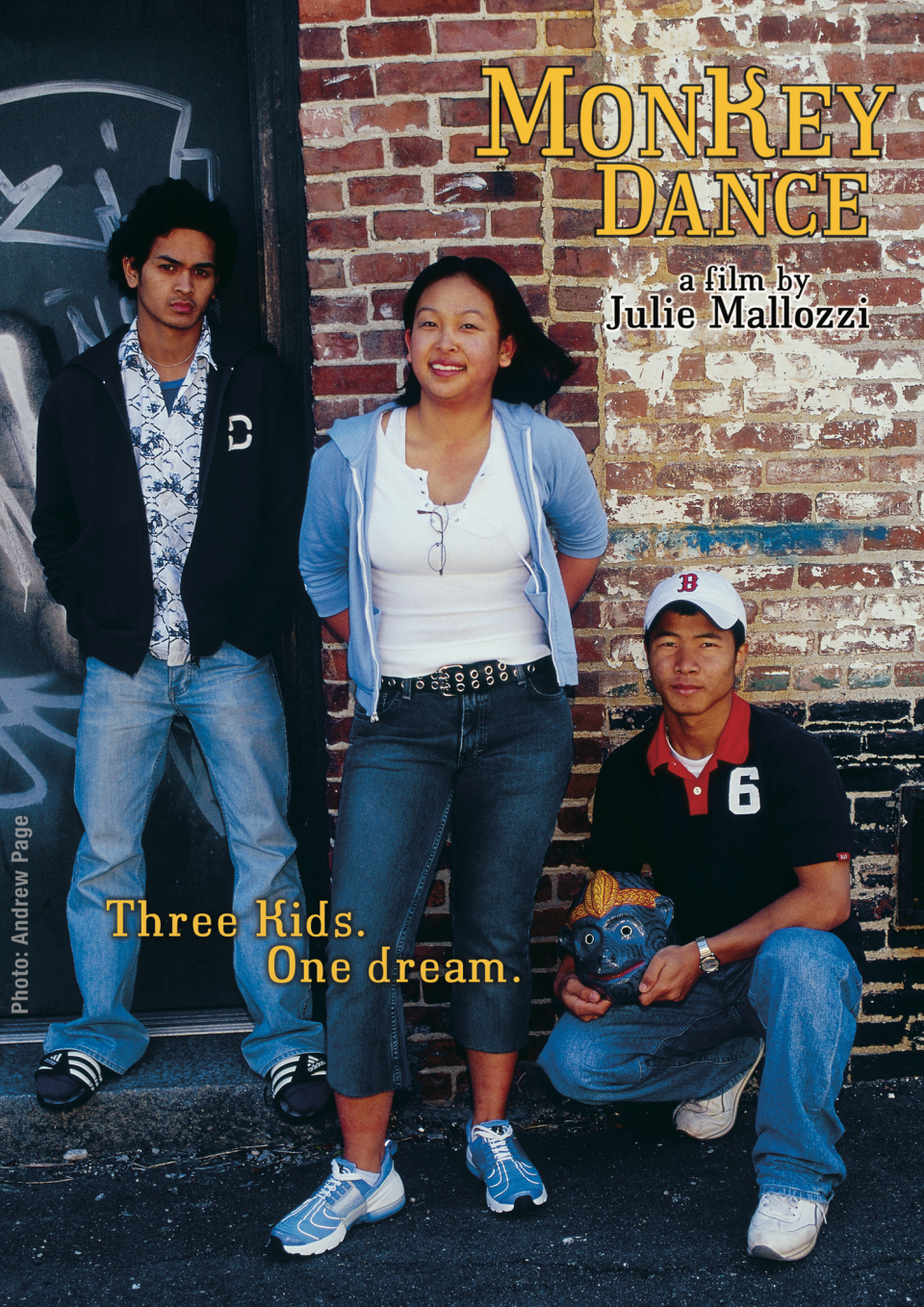 Three individuals, two men and one woman, stand in front of a brick wall and graffiti. The title text floats above the brick wall with the subtitle: "Three Kids. One dream."