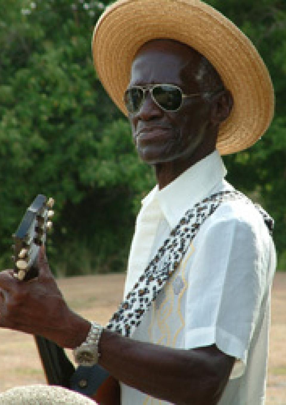 Jamesie with his guitar looking at the camera