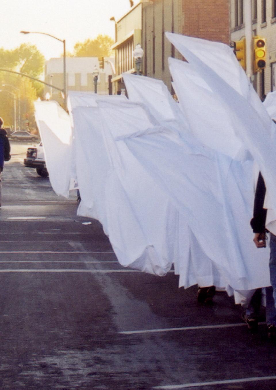 Angel Action protesters proceed through downtown Laramie to counter Rev. Fred Phelps & co.