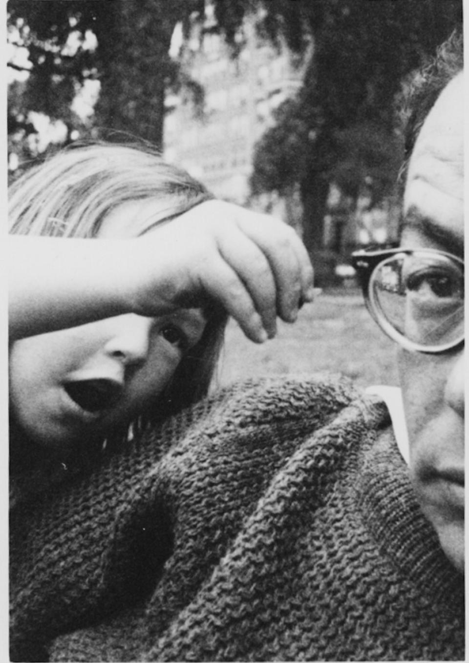 Black and white photograph of the filmmaker as a child, reaching toward her father.