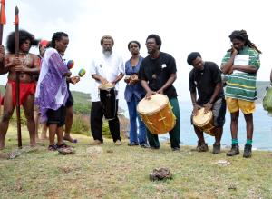 A group of Caribs are drumming and dancing in honor of lost ancestors. 