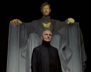 Krzysztof Wodiczko standing in front of projection on an Abraham Lincoln statue for A House Divided, Galerie Lelong New York, US (2020)