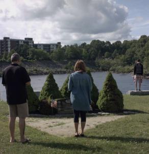 Hallie, John and Connor at Memorial, with their backs to the camera.