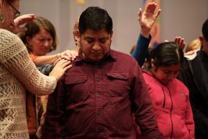 Church members praying around Lucio