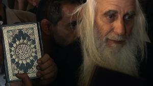 Rabbi with Quran next to his head