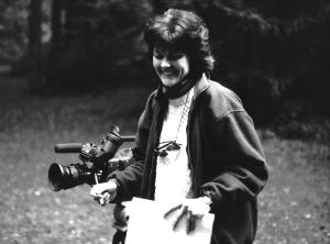 Nila Bogue, Filmmaker, standing by camera