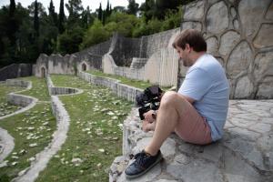 Camera man holding camera whilst filming the Partisan Memorial Cemetery