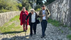 Director and Producer walks with one of the families to the Partisan Memorial Cemetery