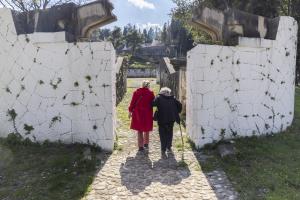 Two ladies pass through the entrance of the Partisan Memorial Cemetery