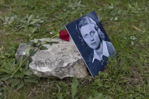 Broken stone flower with Portrait of one of the young partisans who were killed during WW II