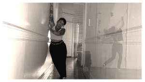 Black and white image of two Telephone dancers (each overlaid) leaning on separate walls
