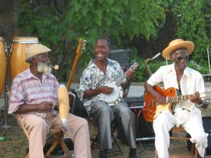 George Rawlins, King Derby & Jamesie sitting and playing music 