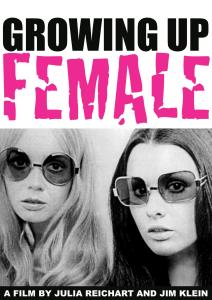 A black and white image from the 1970s of two women, blond and brunette, who stare at the camera, lips parted, with the same still, unsmiling expression. Both wear translucent oversized sunglasses. Text, "Growing Up Female. A film by Julia Reichart and Jim Klein."