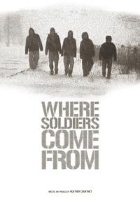 A grainy black and white still from the New Day film Where Soldiers Come From. A row of people shrouded in dark coats and hoods amble down a snowy path. Their surroundings are blurred out with snow but some bushes and trees are visible on the sides of the road. Title, "Where Soldiers Come From".