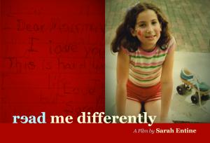 Postcard for "Read Me Differently" has the "e" in "read" backward. A girl of about ten years old, likely in the early eighties, wearing a shirt with rainbow stripes and red shorts, sitting next to a blue Adidas roller skate with a yellow sole and big black wheels. She has facepaint on her cheeks.