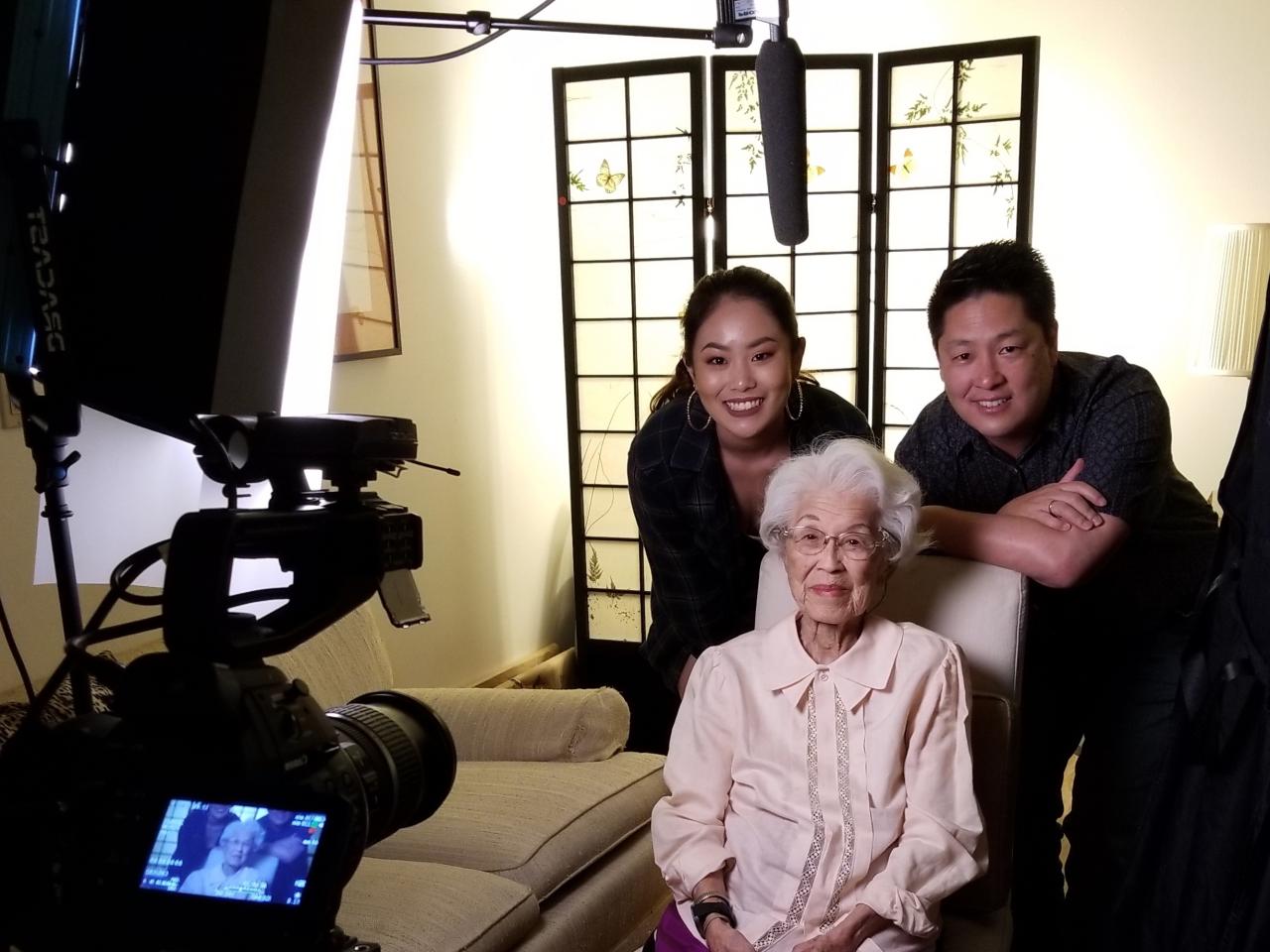 Filmmaker Jon Osaki with his daughter Mike and Aiko Herzig Yoshinaga pose together for a photo while filming Aiko's interview.
