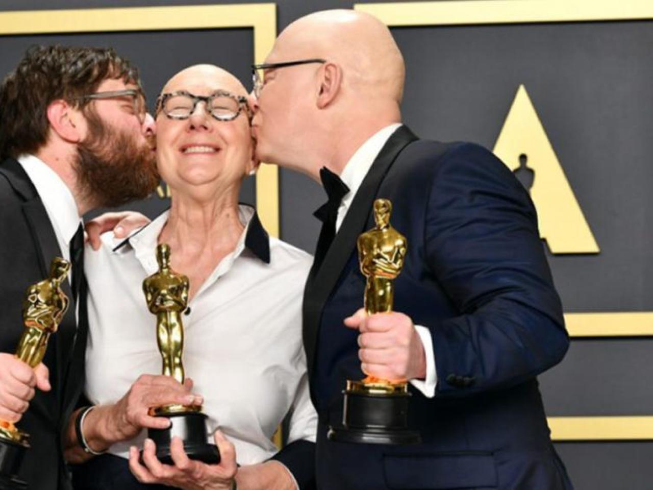 Woman and two men with Oscars