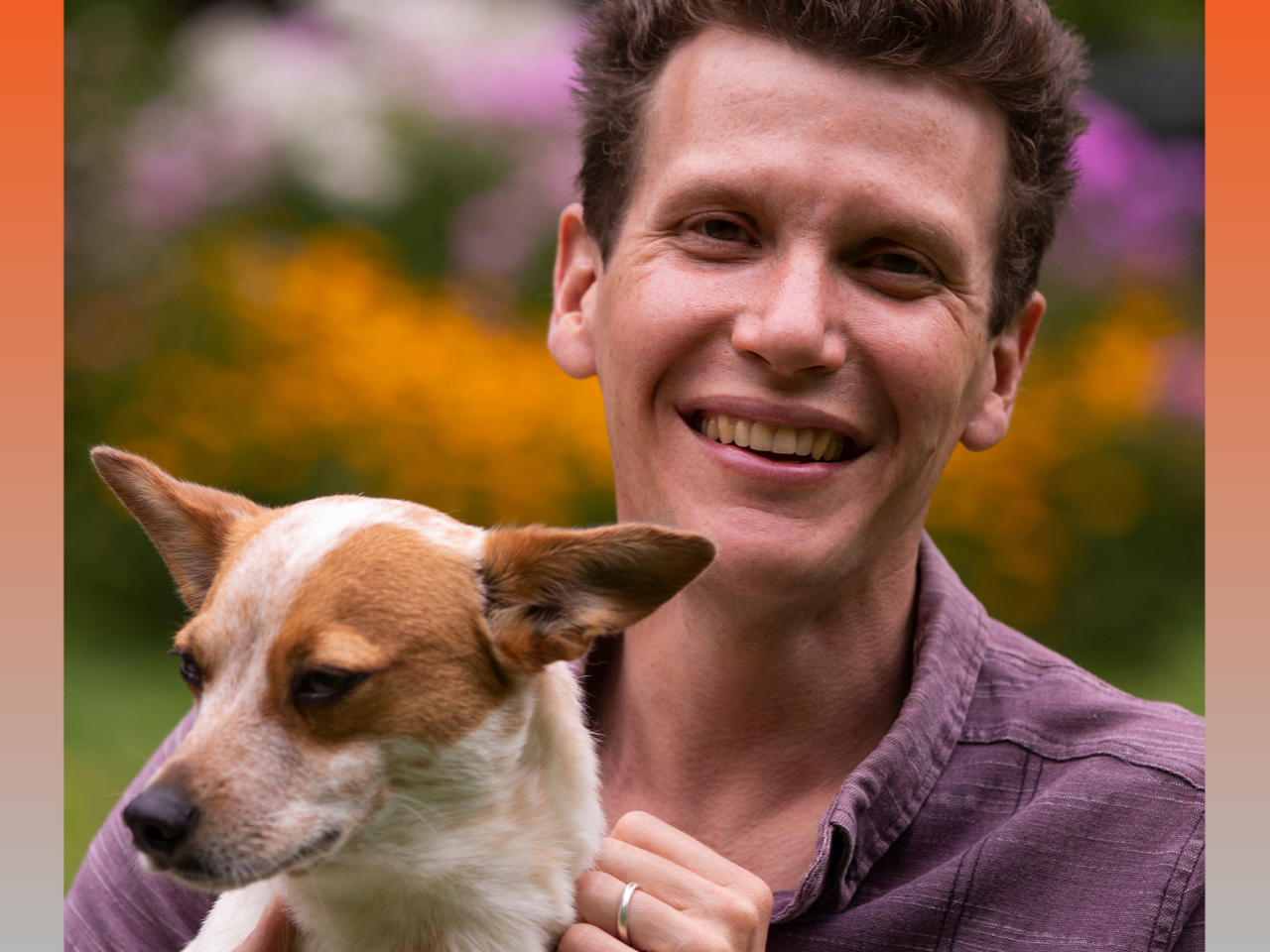 Photo of Brad Heck looking at the camera and holding a small dog.