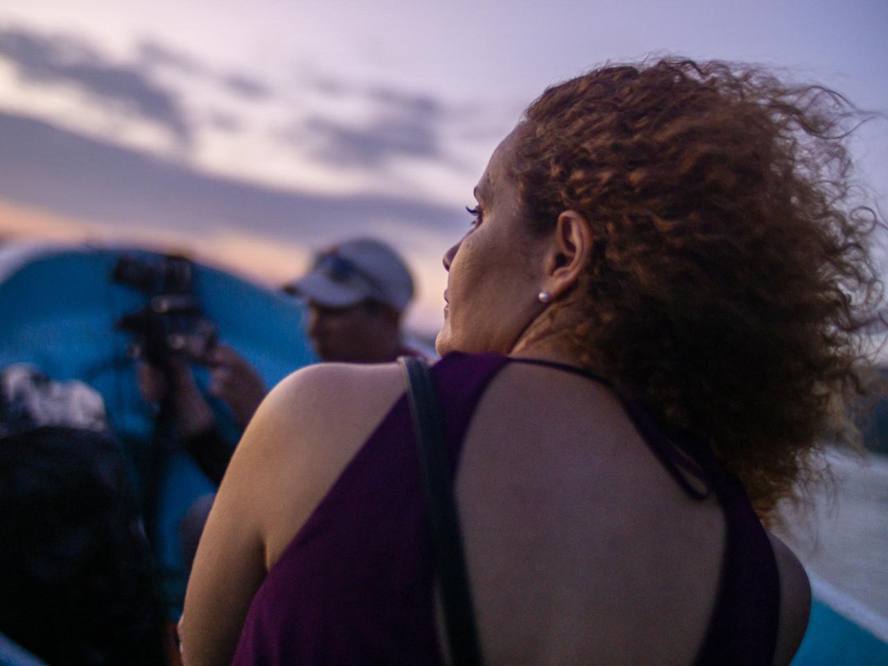 New Day Director Anike Tourse on set outdoors with her back facing away from the viewer.
