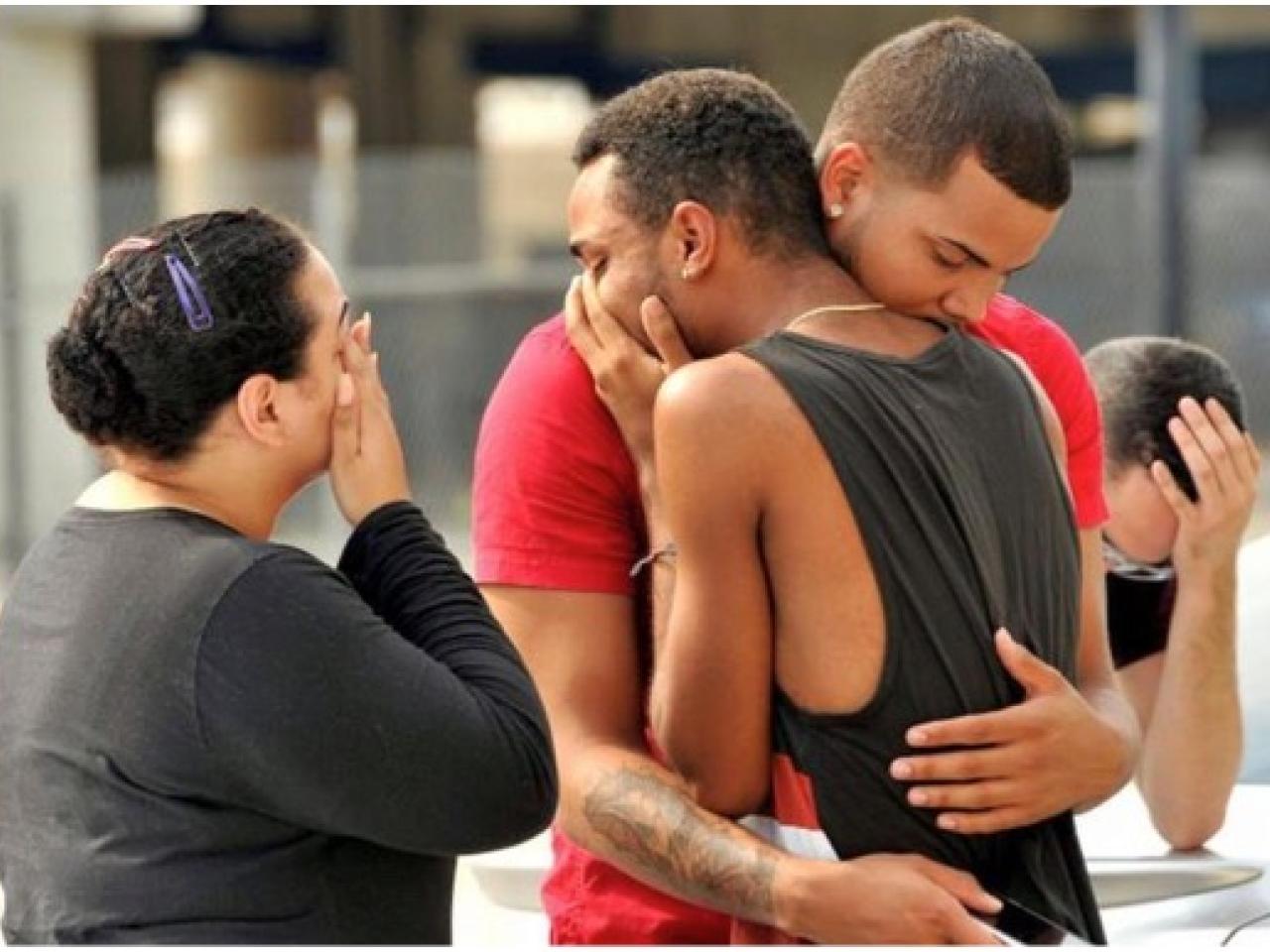 People grieving following shooting attack on a gay nightclub in Orlando, Florida.